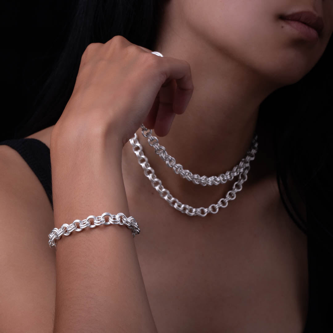 Modèle féminin portant un bracelet chaine artisanal N°19 en argent massif très original, habille le poignet avec douceur. Son double assemblage de maillons lisses se positionne très joliment sur la peau - Itsara Bijoux