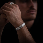 Bracelet homme en argent N°08 jonc ouvert artisanal traditionnel ethnique en argent massif poinçonné de motifs de feuilles et de fleurs porté par un modèle masculin- Itsara bijoux